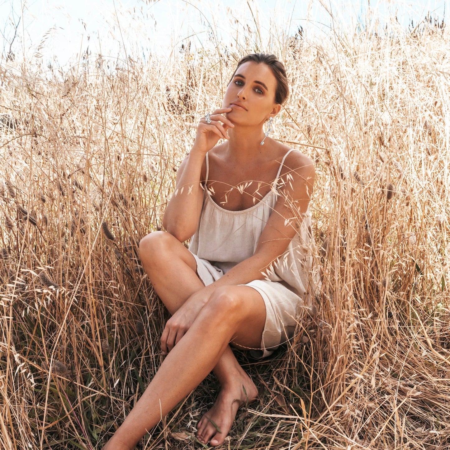Model in the Grass with Silver Spikethorn Statement Bar Ring and Earrings