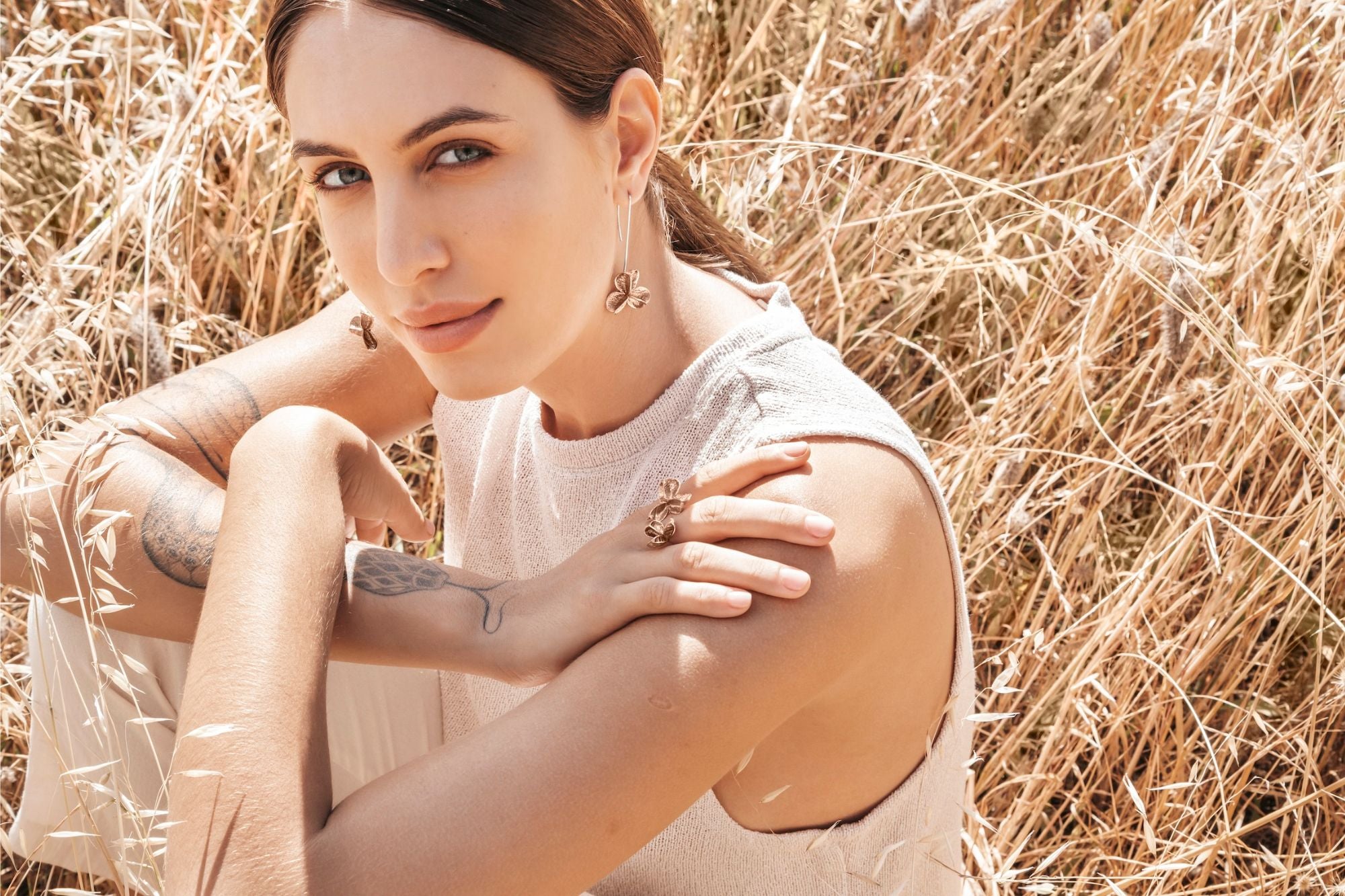 model wearing bronze double pod ring and large long spikethorn hook earrings by Tiffany Marx