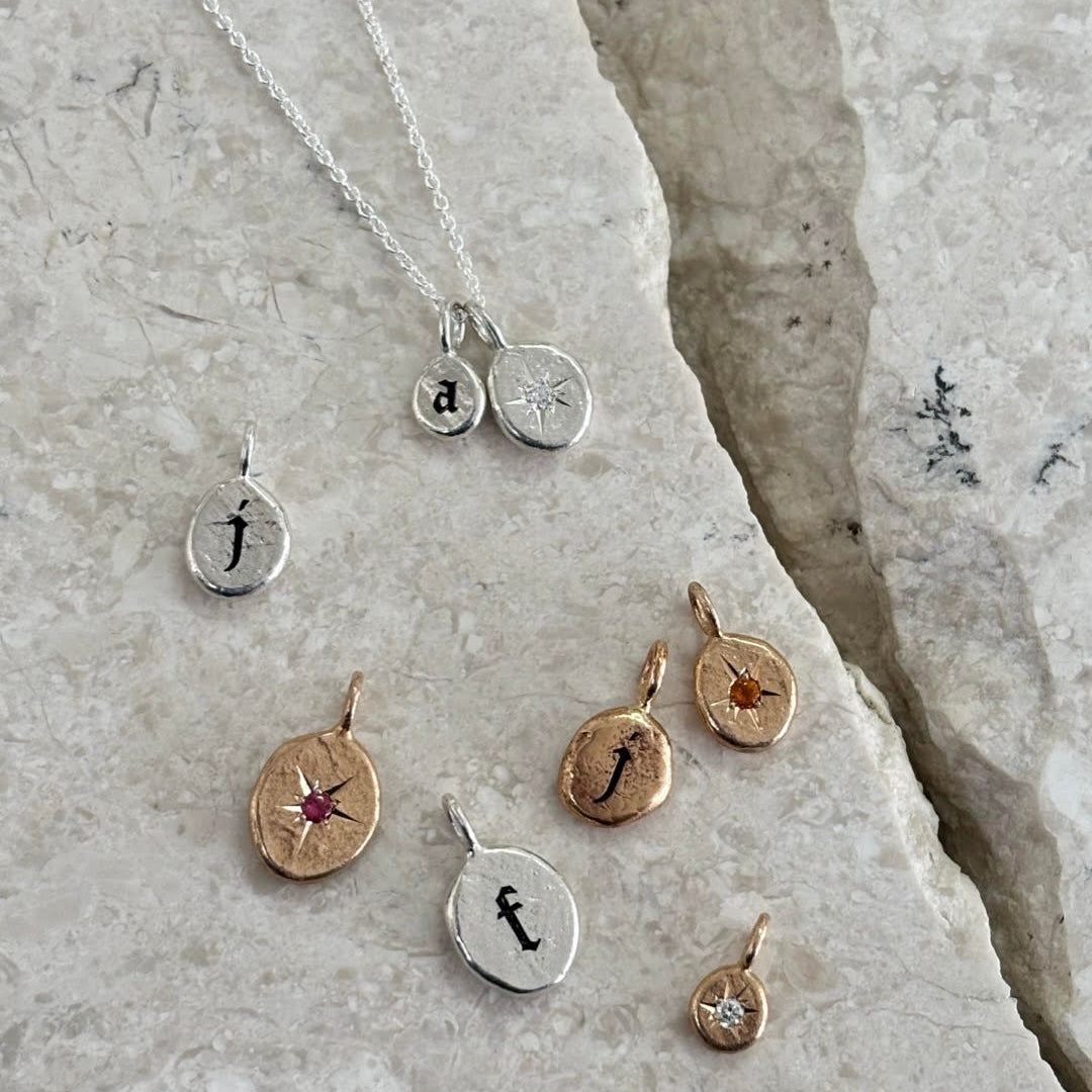 Different sizes and examples of gothic-style letters and birthstones
