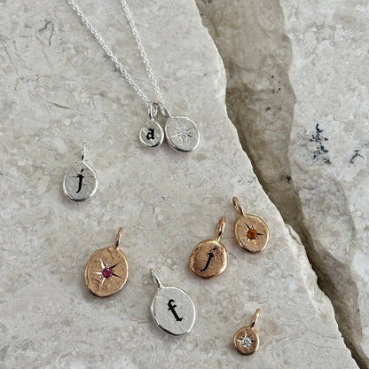 Different sizes and examples of gothic-style letters and birthstones