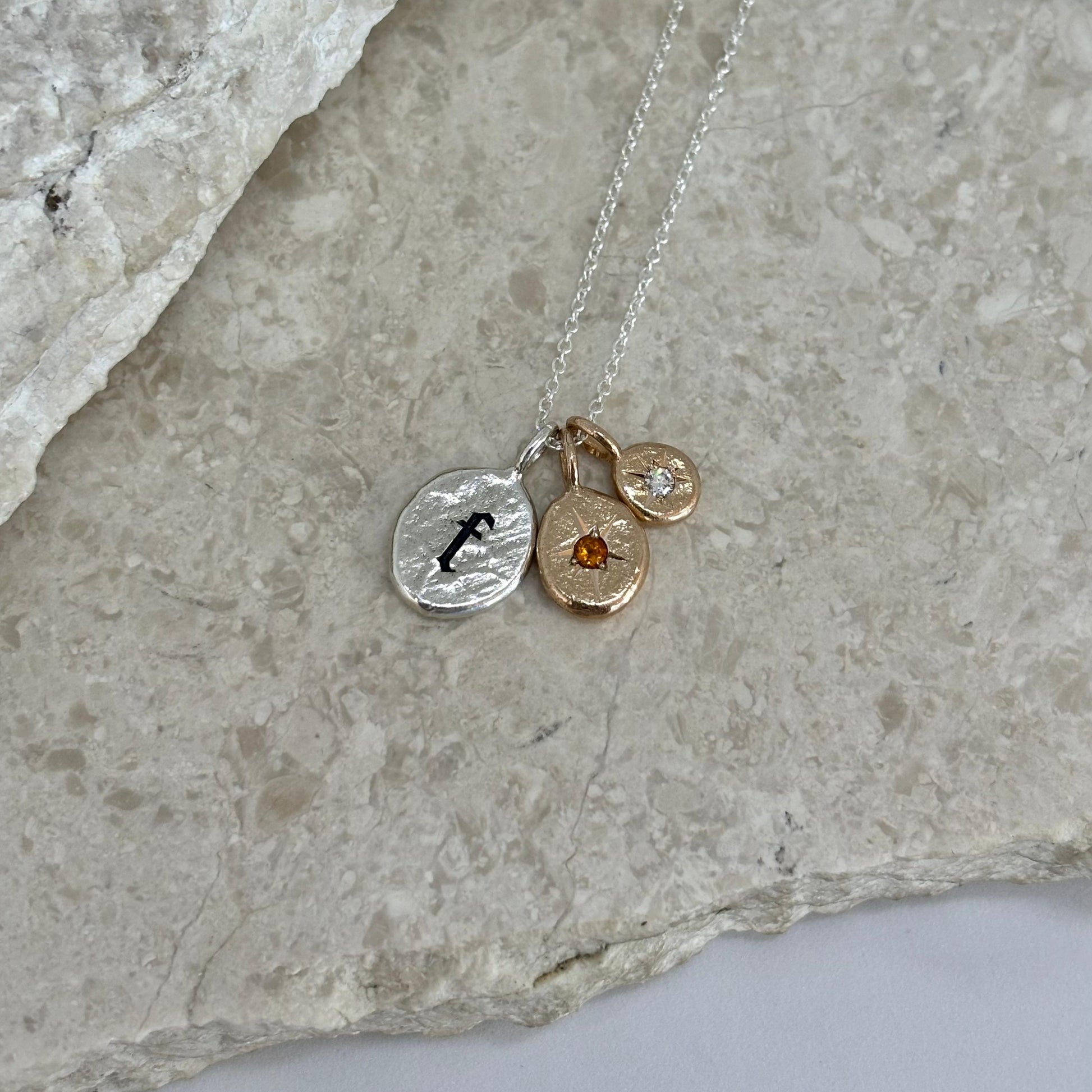 Necklace of large Silver F, medium and small bronze sized birthstones 