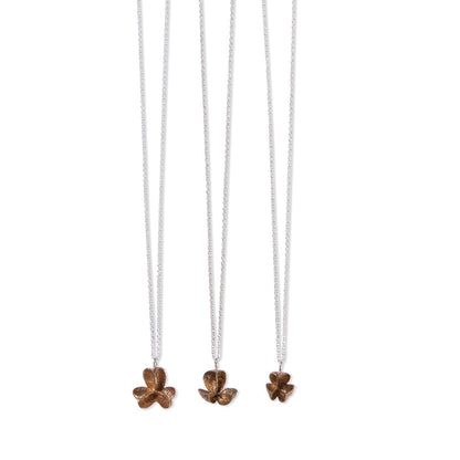 three different sizes of single bronze spikethorn pendant by Tiffany Marx on a silver chain