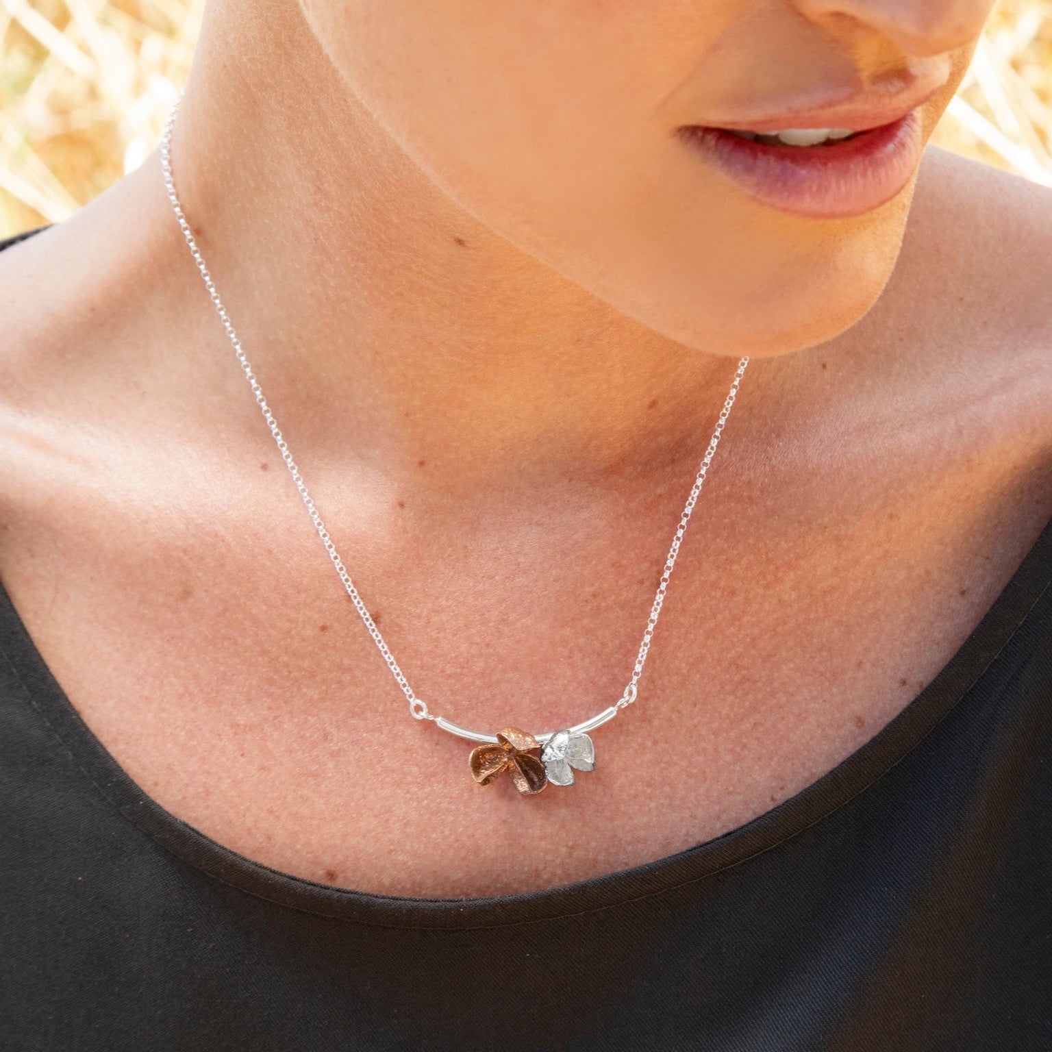 Spikethorn Curved Bar Necklace - 2 pods on model by Tiffany Marx