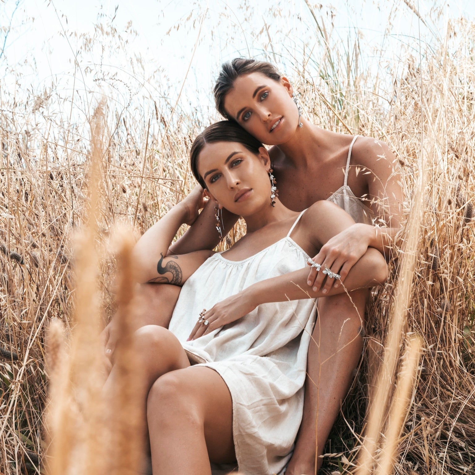 Silver Spikethorn Statement Bar Ring and Earrings and Two-Tone Statement Earrings on models by Tiffany Marx